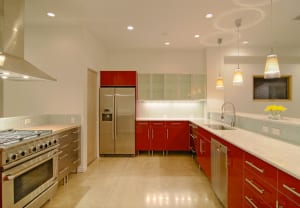 Modern kitchen with polished concrete floors and minimalist red cabinets