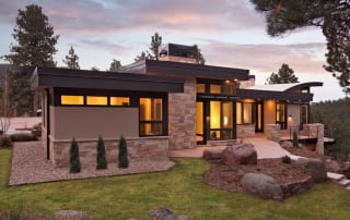 Custom built green home with stone and large windows