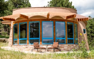 Mountain Kiva pool house with solar power and shades that reduce energy consumption by blocking afternoon sun in the summer. Built by Cottonwood Custom Builders.