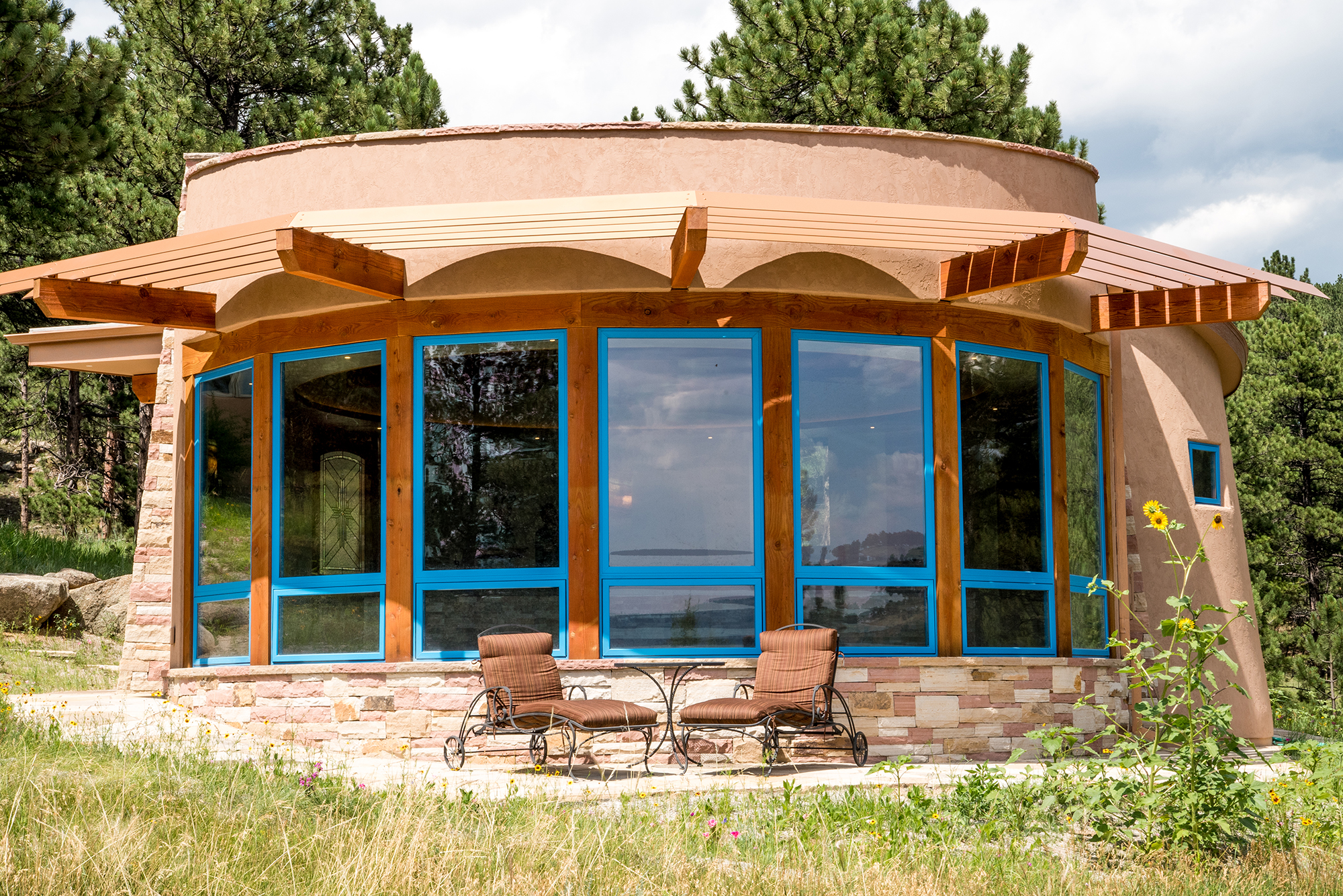 Mountain Kiva pool house with solar power and shades that reduce energy consumption by blocking afternoon sun in the summer. Built by Cottonwood Custom Builders.