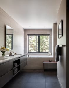 Light filled custom bathroom with floating vanity and inset tub
