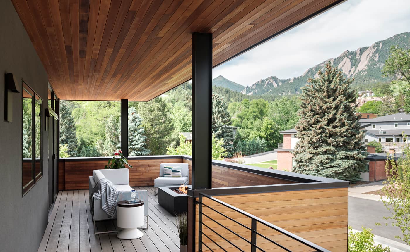 Modern porch design with wood ceiling and walls and view of mountains