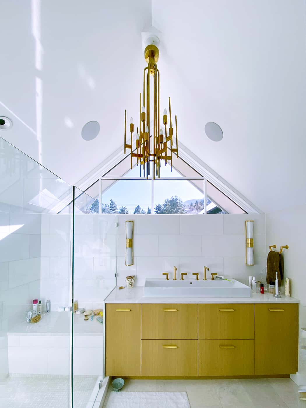 Modern master bathroom with white walls and brass accents and quartz counter tops