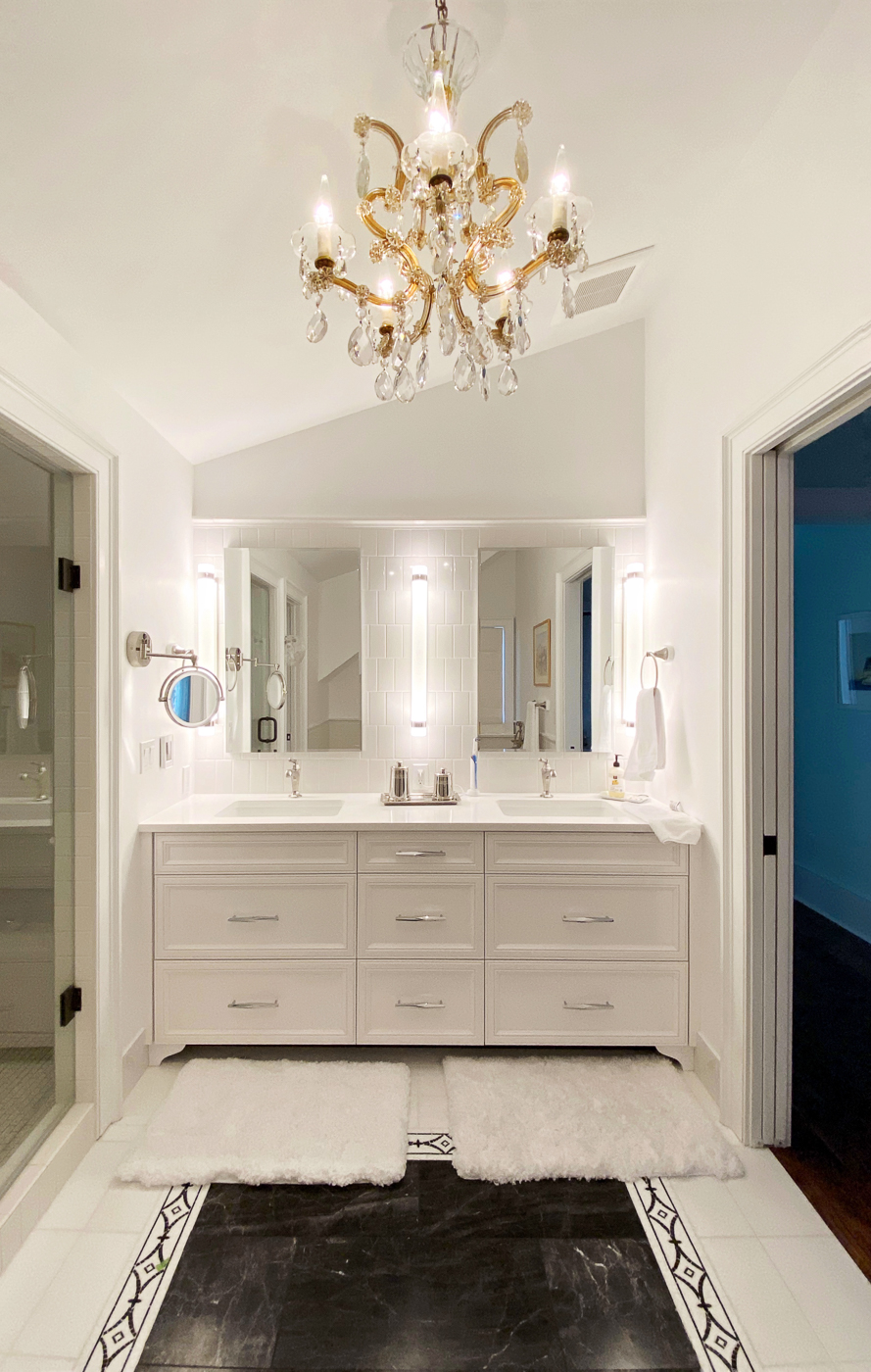 Remodeled bathroom with chandelier and custom marble and fasos tile floor