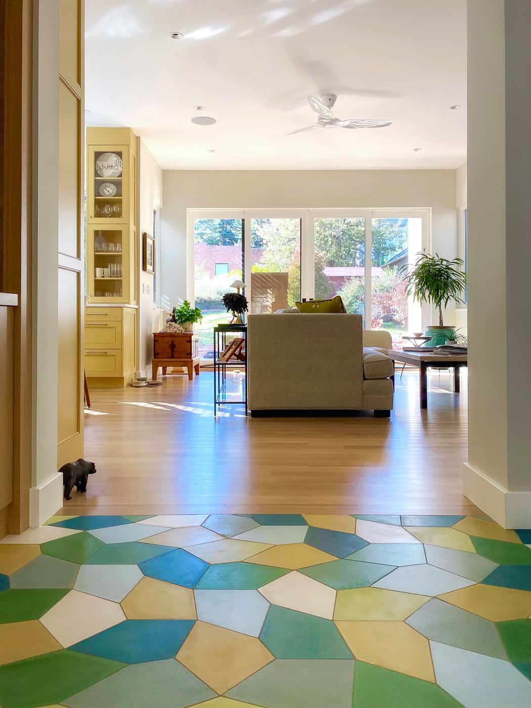 Boulder remodel - entryway with brightly colored custom geometric tile looking into sunny, open floor plan livingroom and kitchen