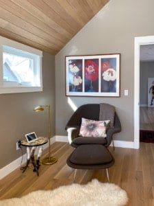 Sitting area in bedroom with wood paneled ceiling