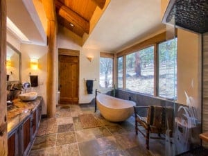 Rustic bathroom remodel with soaking tub and big windows