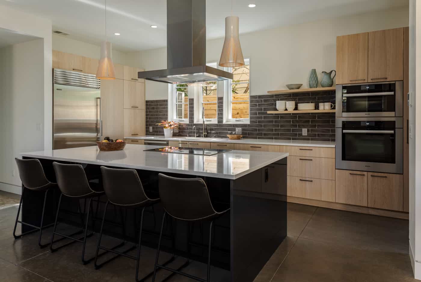 Contemporary kitchen with island and light cabinets in Boulder custom addition
